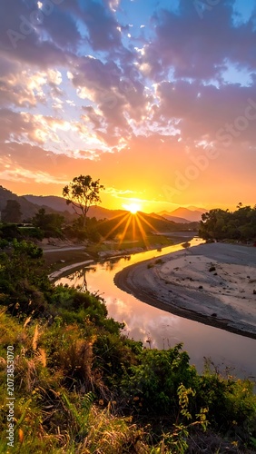 Sunset over serene river landscape scene.