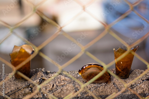 Konstfotografi Close-up of Sharp Brown glass shards used as a fence deterrent.