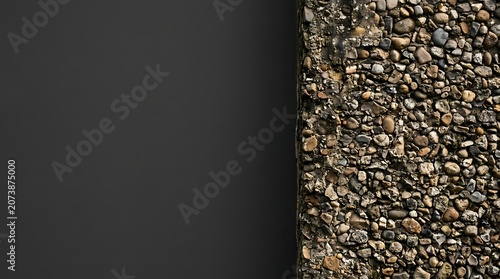 Minimalist dark grey wall with exposed aggregate concrete texture
