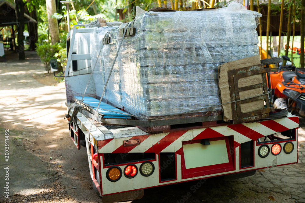 Naklejka premium Pallet plastic wrap delivery transportation truck outdoor logistics cargo shipping industrial heavy equipment vehicle supply freight package distribution warehouse road machinery