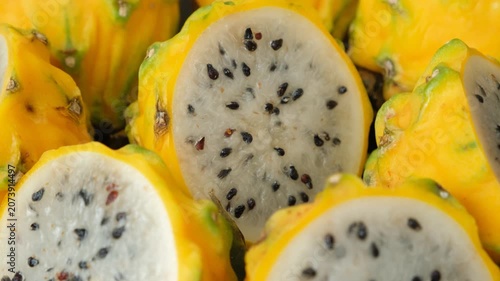 Cut ripe yellow pitahaya fruits close up view.