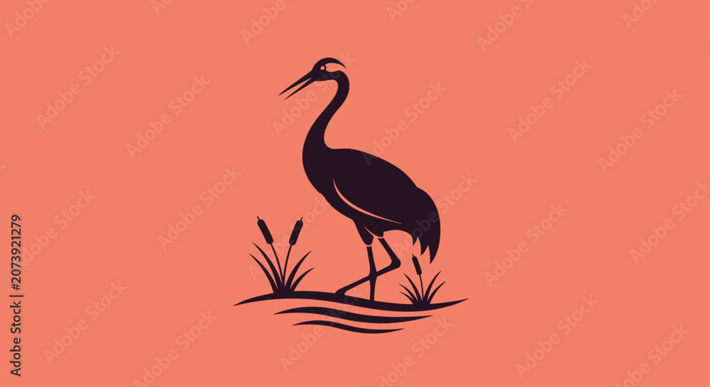 Fototapeta premium Black crane silhouette standing in reeds on orange