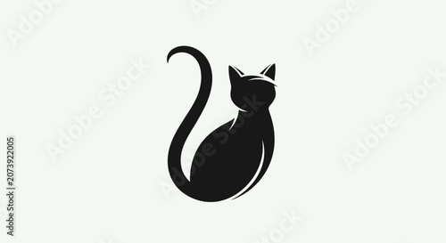 Photography Black cat silhouette with long curved tail.