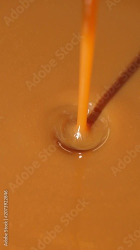 Caramel Sauce Pouring in Slow Motion, Macro Food Texture.