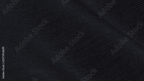 Premium Italian Obsidian Black Solid Wool Lycra Fabric rippling in smooth matte waves of flexible executive suiting texture for formal garments
