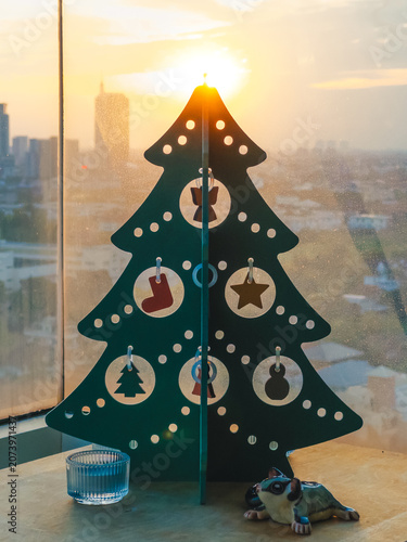 Sunrise wooden Christmas tree on windowsill cozy hygge decor