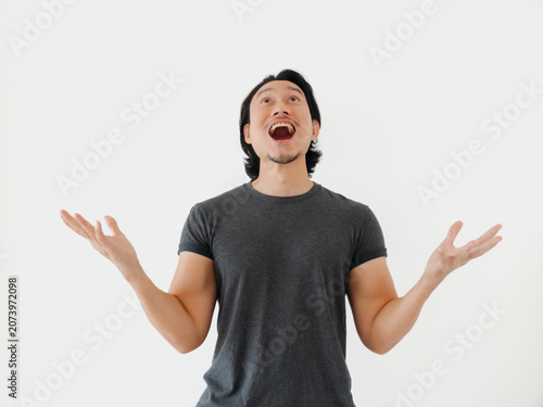 Person in gray shirt displaying awe and thankfulness outwardly