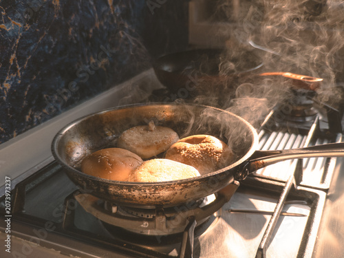 Vivid depiction of fragrant buns steaming and cooking actively on gas stove