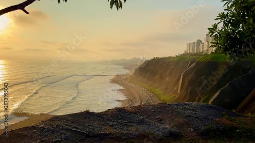 Beautiful sunset reflecting on the pacific ocean from the green cliffs of Miraflores, Lima