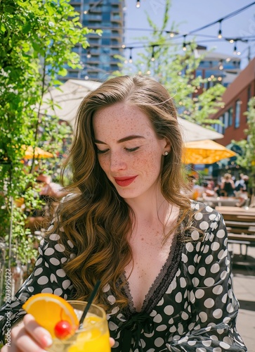 Freckled Woman Enjoying Summer Drink on Sunny Outdoor Patio