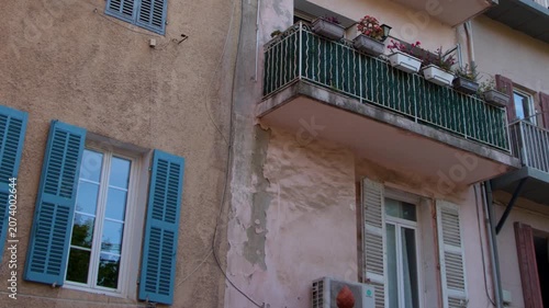 Traditional Mediterranean Apartment Building Facade with Blue Shutters in Cassis