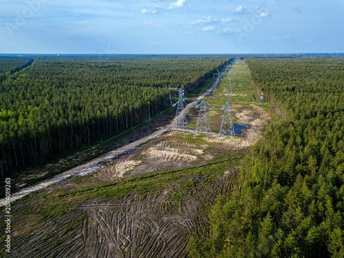 Russia, Leningrad Oblast, Tikhvin, Aerial view of electricity pylons in middle of deforested area