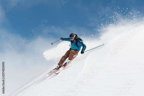 Skier in action on powder snow at Arlberg mountain