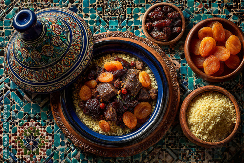 Traditional Moroccan tagine with tender meat, dried apricots, prunes, and couscous