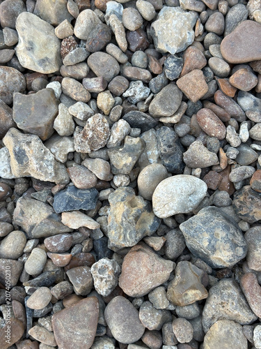Natural pebble stone texture background with rounded river rocks