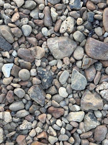 Natural pebble stone texture background with rounded river rocks