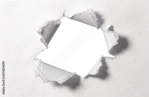 фотографія White torn paper hole in center to insert your text for advertising content prom