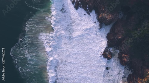 Aerial overhead waves breaking on the coastline
