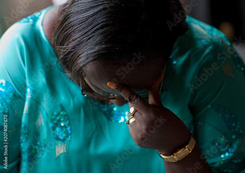 Rwandan woman praying during a sunday mass in a church, Kigali Province, Kigali, Rwanda