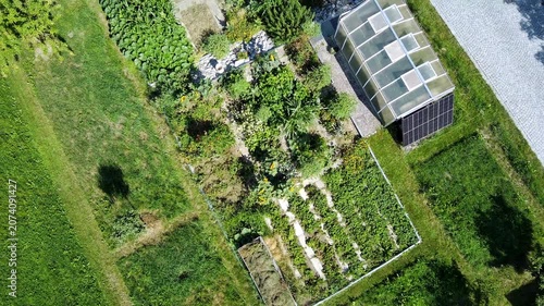 Aerial view of sustainable permaculture garden design with ponds, greenhouse and herb spiral, biodiversity and regenerative landscape architecture