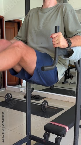 Video of a man performing abdominal exercises in a modern gym. Fitness and healthy lifestyle concept representing core strength, endurance, physical training and overall wellness.