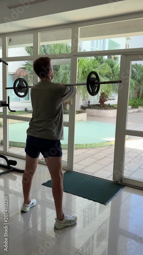 Video of a man performing dumbbell exercises in a modern gym. Fitness and strength training concept representing an active lifestyle, muscle building and personal health.