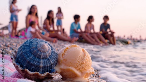 A Serene Beach Scene at Sunset Featuring Delicious Ice Cream in Shells Alongside a Group of Friends Enjoying a Relaxing Evening by the Water's Edge