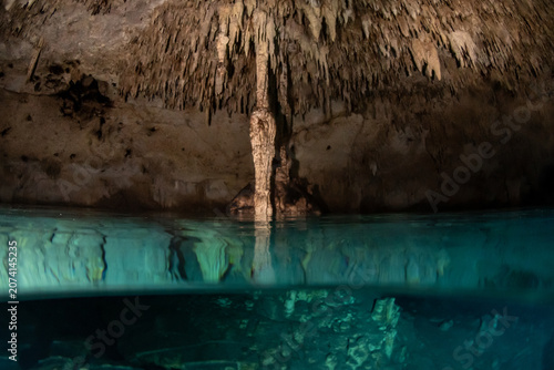Konstfotografi Half underwater split view inside a Yucatan cenote air chamber with limestone fo