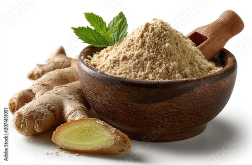 Ginger root, ground spice, wooden bowl, and mint sprig