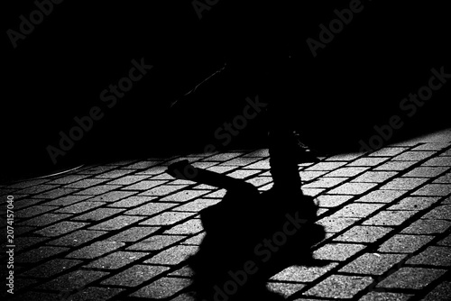 Silouette feet on coblestone in street