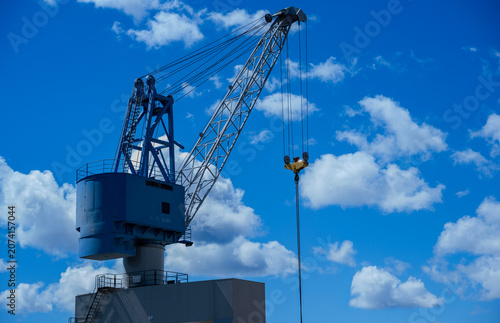 Blue Mobile Harbor Crane Against Blue Sky with White Clouds