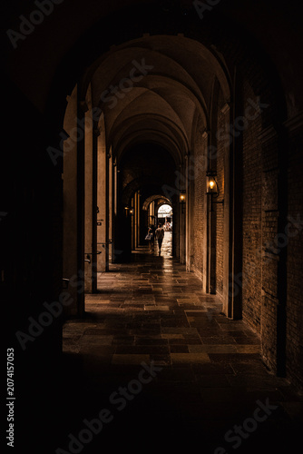 Dark moody arch with two people