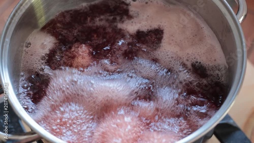 Octopus tentacles cooking in boiling water with steam rising