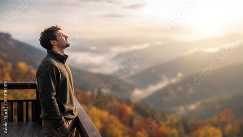 Profile view of an anonymous man breathing fresh air on a mountain deck at sunset, embodying deep relaxation, freedom, and triumph after a long autumn hike