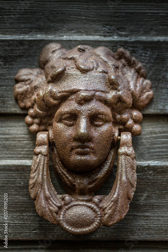 Antique cast iron face door knocker