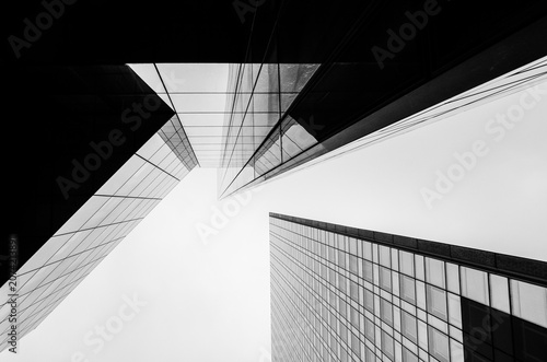 Modern office towers converging toward the sky in black and white