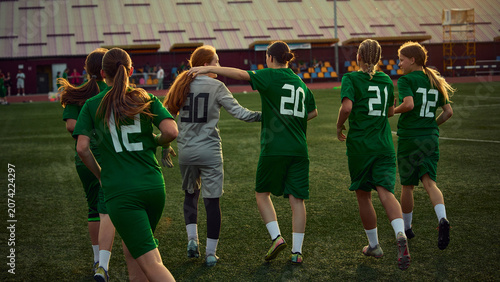 Tableau sur toile Teenage soccer teammates walking with goalkeeper after training match