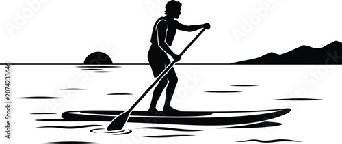 Konstfotografi Silhouette of a person paddleboarding on water with a sunset landscape black and