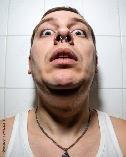close-up of shocked person looking into phone
