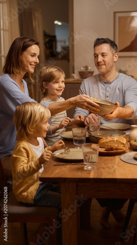 Family sharing home cooked dinner at dining table