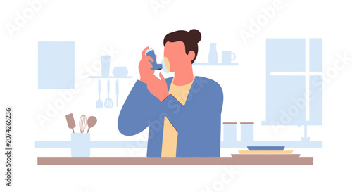 Person using inhaler for asthma relief in modern kitchen setting.