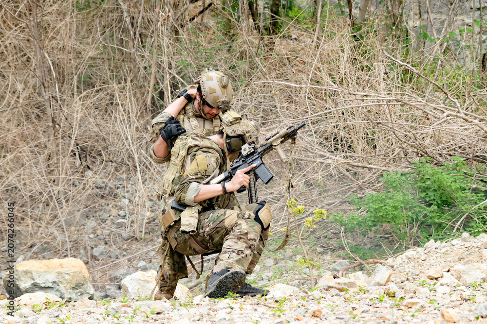 Fototapeta premium Special forces units, armed with war weapons are joining forces in unity surprise attack preparing mission to assault the enemy military.