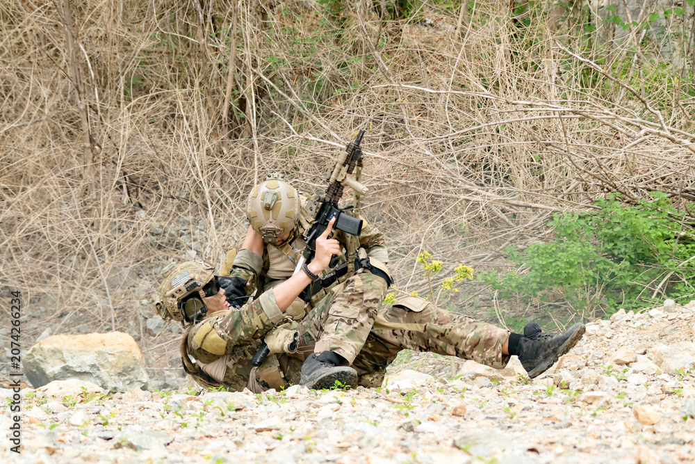 Fototapeta premium Special forces units, armed with war weapons are joining forces in unity surprise attack preparing mission to assault the enemy military.