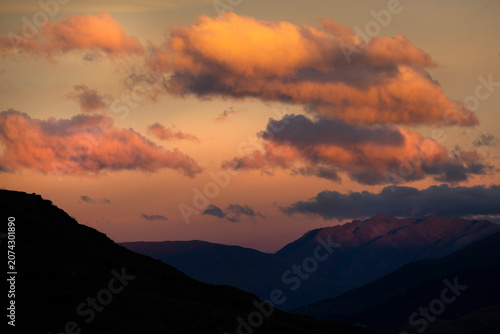 Silhouette of distant mountains against the golden evening glow.