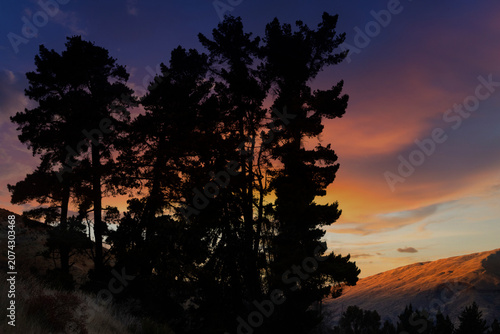 Silhouette of mountains and forests at dusk.