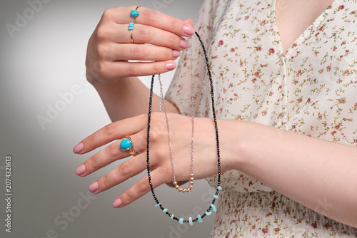 Obraz na płótnie Elegant Display of Turquoise and Beaded Jewelry Highlighted by Delicate Hand Ges