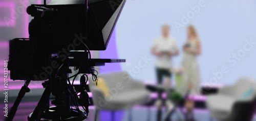 Bild auf Leinwand TV Broadcast camera capturing presenters on modern studio stage