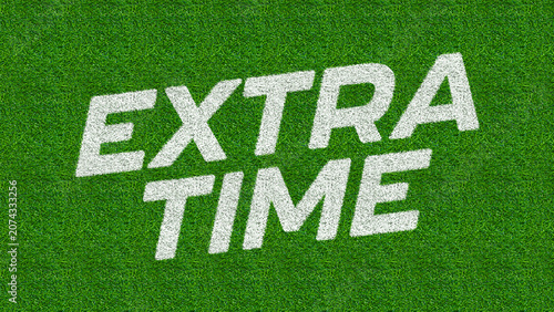 Foto White lettering clearly spells out EXTRA TIME across a vibrant green sports field