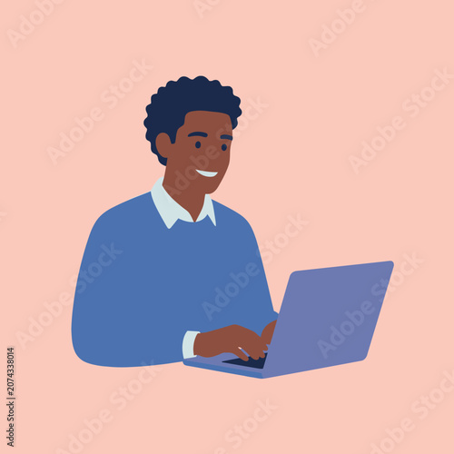 A happy young man works on his laptop computer at home