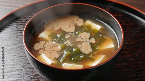 Delicious Steaming Miso Soup in Black Lacquer Bowl with Tofu and Seaweed - A Traditional Japanese Cuisine Delight for Food Lovers
